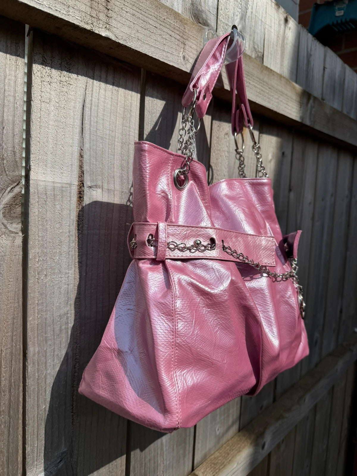 Vintage Dressing pink slouch shoulder bag with chain detail and large tote design.