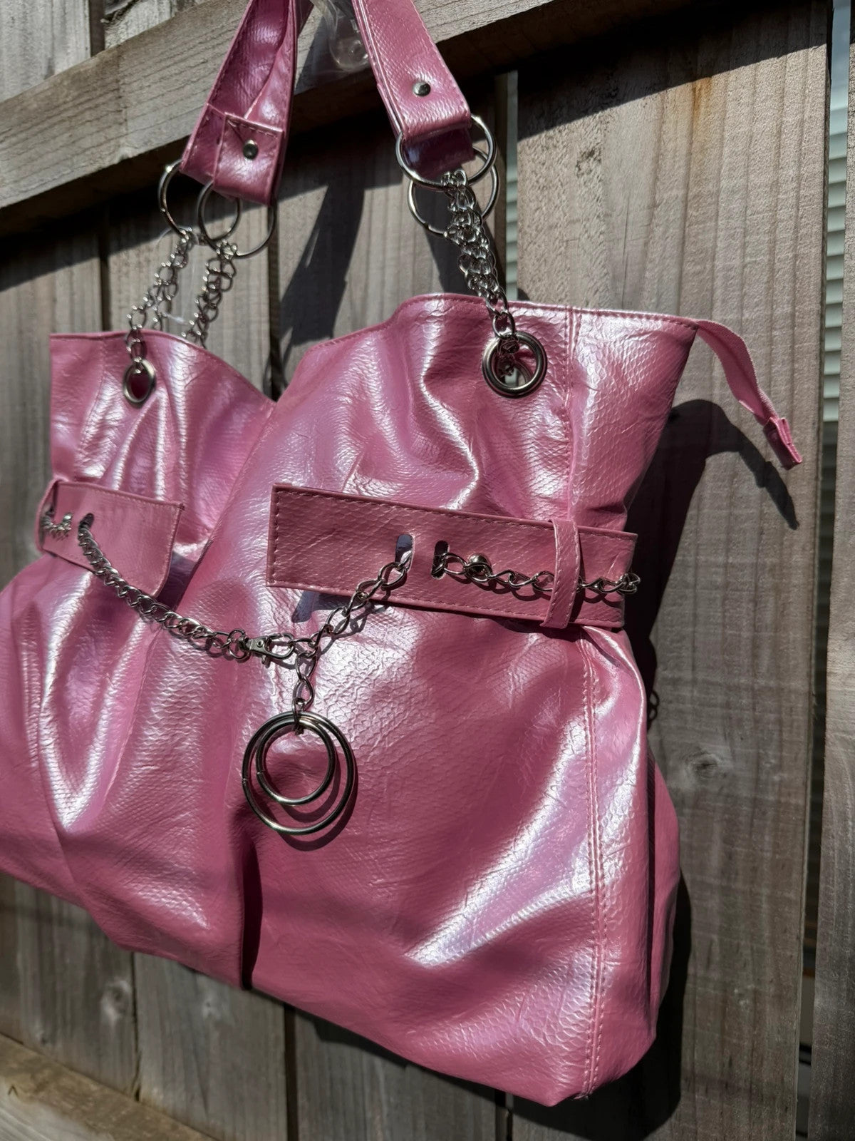 Vintage Dressing pink slouch shoulder bag with chain detail and large tote design.