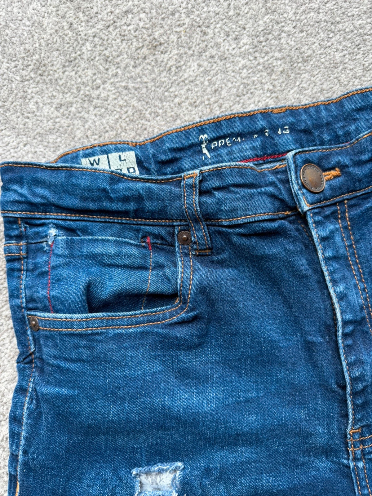 Ringspun blue denim shorts with distressed details and rolled hem.