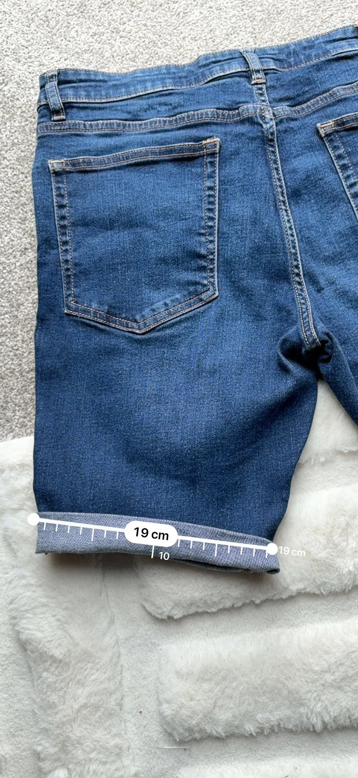 Ringspun blue denim shorts with distressed details and rolled hem.