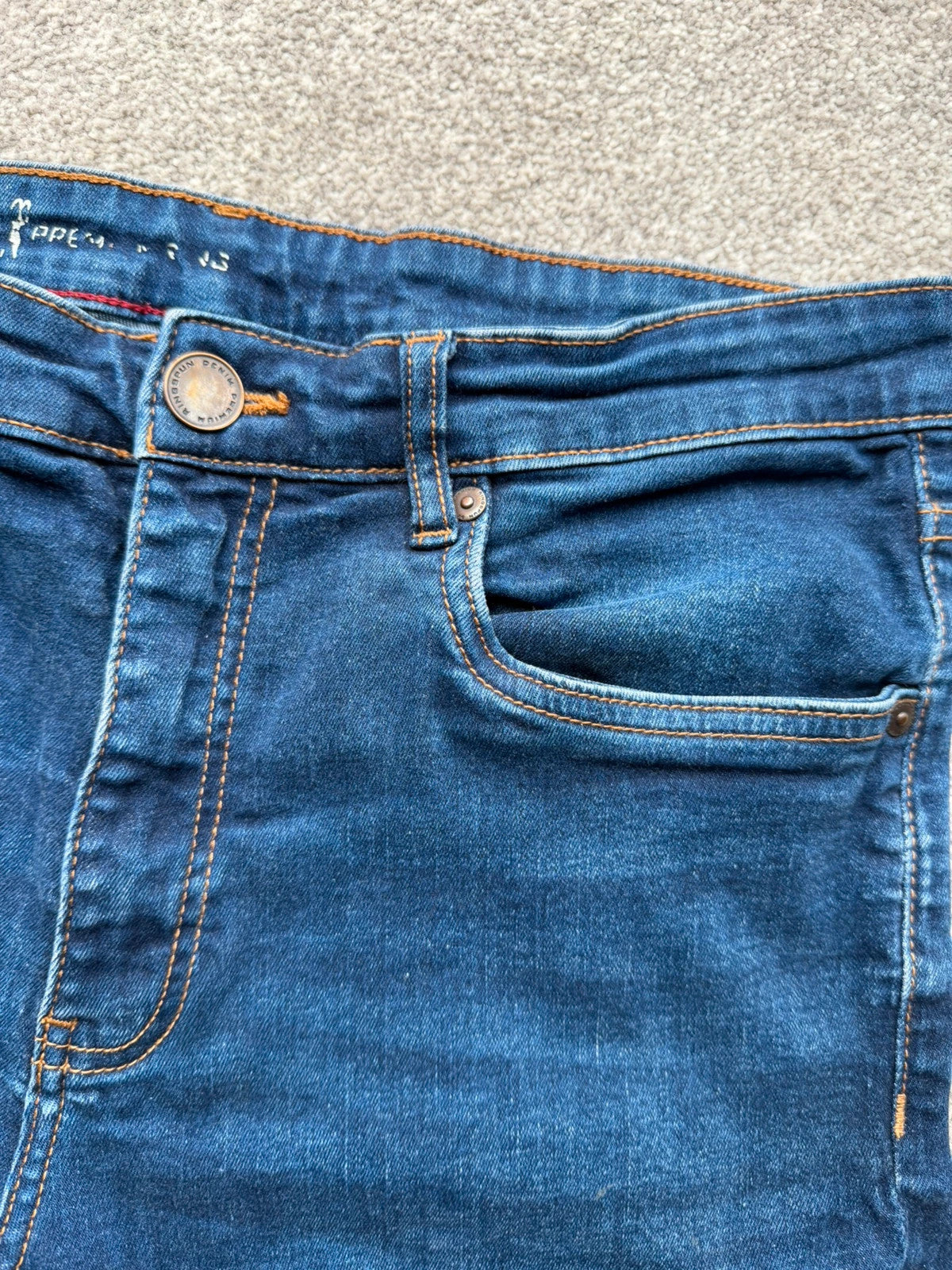 Ringspun blue denim shorts with distressed details and rolled hem.