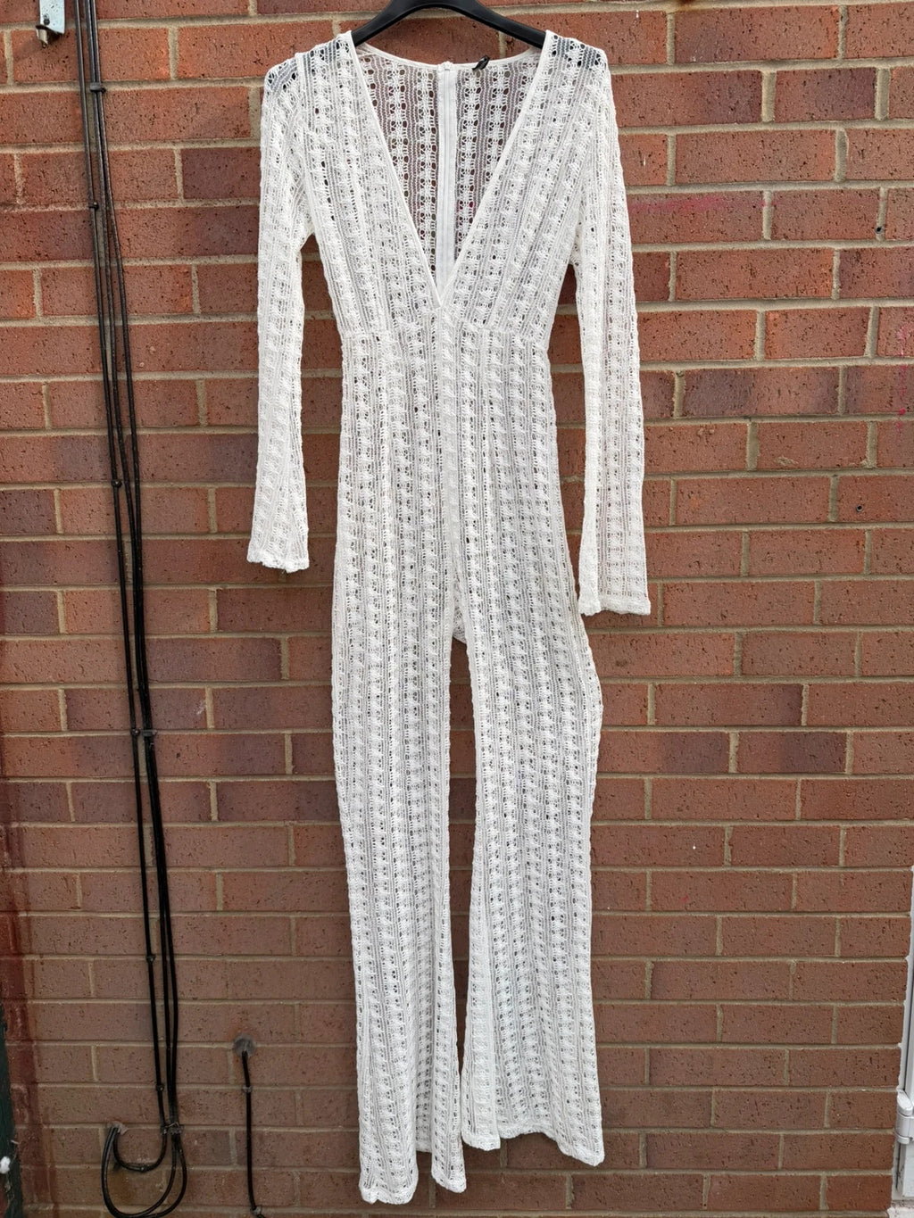 PrettyLittleThing white crochet lace jumpsuit with wide leg design, boho style.