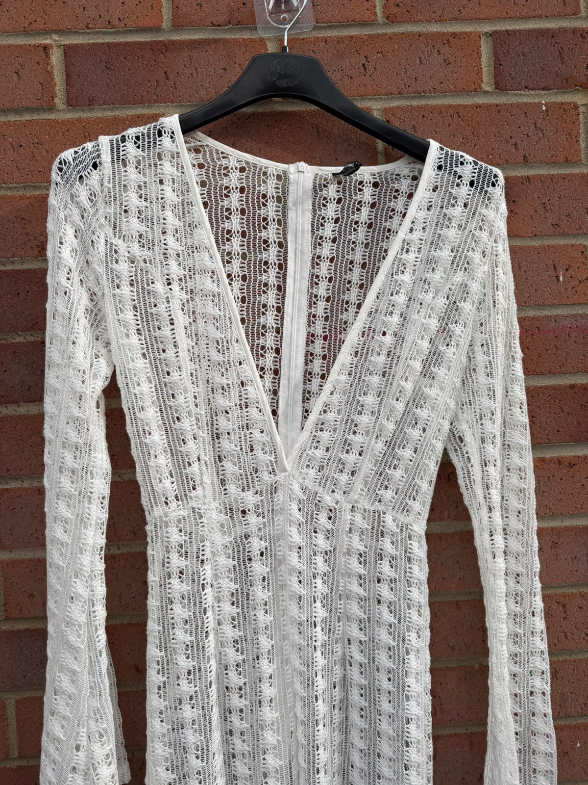 PrettyLittleThing white crochet lace jumpsuit with wide leg design, boho style.