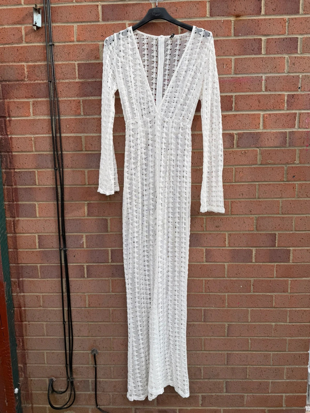 PrettyLittleThing white crochet lace jumpsuit with wide leg design, boho style.