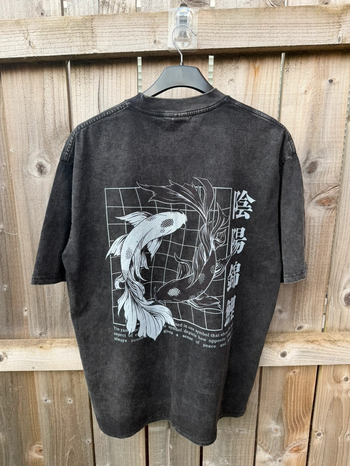 Vintage Dressing black and grey acid wash graphic tee featuring koi fish design.